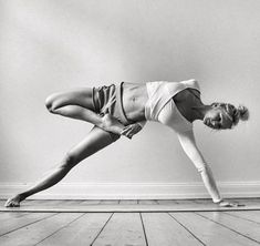 a woman is doing yoga on the floor