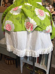 "Cute as can be! Apple green with whimsical flowers in white and neon pink. Attached white cotton and lace petticoat. Two tiny Frey's in fabric at the hem pictured. Easily repaired. Measurements: 26\" waist 42\" free flared hips 70\" circumference at hem 1-3/4\" waistband 7-1/2\" back nylon zipper with two button waist closure 19\" from top of the waistband to hem from the back" Green Cotton Ruffled Bottoms, Pink Cotton Skirt With Lace Trim, White Cotton Skirt With Attached Cancan, Spring Cotton Skirt With Lace Trim, White Cotton Petticoat With Attached Cancan, White Lined Cotton Petticoat, Vintage Petticoat With Attached Cancan For Spring, Spring Cotton Tiered Skirt Petticoat, Spring Cotton Petticoat With Tiered Skirt