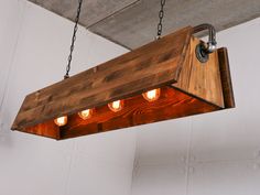 a wooden light fixture hanging from a ceiling