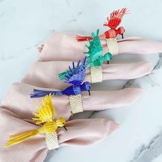 four napkins with colorful bird decorations on them