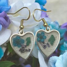 These are lightweight Flowers enclosed in heart dangle earrings. These are a unique creation as I only made one. These are amazing and you can dress up or down and they are the perfect size for the ear.  I ship same day so they make a great gift or just a self treat. Gold Heart-shaped Flower Earrings, Valentine's Day Heart-shaped Flower Earrings For Pierced Ears, Heart-shaped Flower Earrings For Mother's Day Gift, Handmade Heart-shaped Earrings For Her, Handmade Heart-shaped Earrings As A Gift For Her, Handmade Open Heart Earrings For Gift, Handmade Teardrop Heart Earrings For Gifts, Handmade Heart-shaped Flower Earrings For Gift, Gold Heart-shaped Flower Earrings As Gift