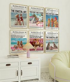 a living room with posters on the wall and a chair next to it, in front of a white cabinet