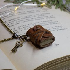 an open book with a key attached to it