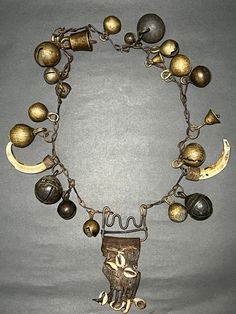 Antique Primitive Shaman Metal Chain Necklace with Brass & Bronze Bells, Leather, Seashells, and Wild Boar Teeth from Western Nepal (Jumla). This is very beautiful and Antique Primitive rare Shaman spiritual holy Necklace with Brass & Bronze Bells, Leather, Seashells, and Wild Boar Teeth from Western Nepal (Jumla). Shamans would wear necklaces like these when performing rituals or ceremonies. Collector and museum quality piece. Measurements: Length - 29 inches Weight - 808 grams * Colors may var Bronze Pendant Necklace With Charms, Vintage Large Pendant Jewelry For Rituals, One Of A Kind Bronze Necklace For Festival, Vintage Jewelry With Large Pendant For Rituals, Spiritual Large Pendant Jewelry For Rituals, Artisan Dangle Charms Jewelry, Unique Bronze Necklace For Festivals, Traditional One-of-a-kind Brass Jewelry, Ceremonial Large Pendant Bronze Jewelry