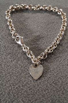 I am offering you this spectacular sterling silver (stamped) Classic fancy rolo link charm style bracelet. There is a heart shaped dangle charm. There is plenty of room to put additional charms on it. It has a very dimensional, sturdy and wide. There is a sturdy lobster claw closure. It measures approx. 7.5 inches in length, and is approx. 3/4 inch wide. It weighs app. 13 grams. Buyer pays all shipping and handling fees, we will always combine shipping. Elegant Sterling Silver Heart-shaped Charm Bracelet, Silver Charm Bracelet With Rolo Chain For Gift, Sterling Silver Charm Bracelet With Rolo Chain, Sterling Silver Charm Bracelet With Rolo Chain For Gift, Sterling Silver Rolo Chain Charm Bracelet Gift, Classic White Gold Charm Bracelet With Heart Charm, Classic White Gold Charm Bracelet With Heart, Elegant Dangle Charm Bracelet With Heart Charm, Classic Heart Charm Bracelet For Valentine's Day