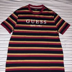 Guess Stripe T Shirt Size Xl, But Fits Like A L .Maroon, Bronze , Navy Blue. Never Worn. Still Has Tag On Them! Striped Crew Neck Top With Logo Print, Guess Shirt, Stripe T Shirt, Striped T Shirt, Shirt Color, Tee Shirts, Navy Blue, Short Sleeves, Mens Shirts