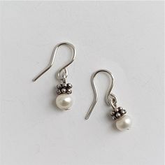 Small silver earrings with an asian silver ornament and fresh water pearls. You can buy the pair or a single earring. Elegant Sterling Silver Nickel-free Pearl Earrings, Elegant Sterling Silver Pearl Earrings Nickel Free, Formal Sterling Silver Pearl Earrings Nickel Free, Formal Sterling Silver Nickel-free Pearl Earrings, Dainty Pearl Earrings With Ear Wire For Gift, Delicate Pearl Earrings With Ear Wire In Sterling Silver, Delicate Sterling Silver Pearl Earrings With Ear Wire, Dainty Pearl White Earrings, Nickel-free White Gold Sterling Silver Pearl Earrings