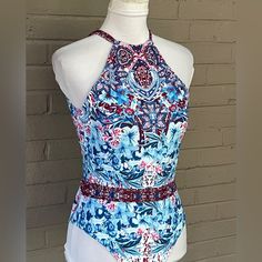 Unique Floral Print In Shades Of Blue , Red And White High Neckline Back Tie Neck Fully Lined Soft Moulded Cups Blue Sleeveless Printed Bodysuit, Blue Printed Sleeveless Bodysuit, Blue Floral Print Stretch Bodysuit, Blue Stretch Bodysuit With Floral Print, Print Swimsuit, Tie Neck, High Neckline, Shades Of Blue, Neck Tie