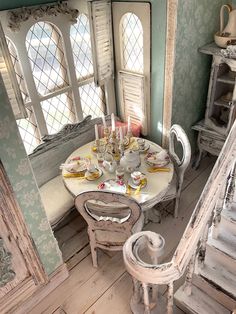 an old fashioned dining table and chairs in a room