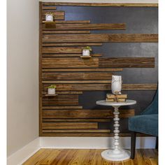 a chair and table in front of a wall with wooden slats on it's sides