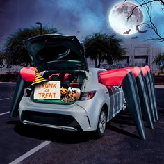 a car with trunk and treat signs in the trunk