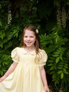 This classic lemon yellow dress is all handmade with intricate hand smocking and embroidered pearls on the chest. This dress is perfect for everyday wear and can be dressed up for formal occasions as well. *  100% Cotton *  2 Layers *  Handmade *  Tie at the back *  Lightweight, soft cotton, comfortable, and ready to play *  Hand wash or machine wash on a delicate setting We are based in Sydney, New South Wales, Australia. We ship within Australia and to other countries as well. The shipping fee Yellow Smock Dress For Summer, Classic Summer Dress With Smocked Back, Yellow Smocked Short Sleeve Dress For Spring, Yellow Smocked Dress With Short Sleeves For Spring, Yellow Short Sleeve Smocked Dress For Spring, Classic Spring Dress With Smocked Back, Yellow Smocked Bodice Dress For Daywear, Yellow Smock Dress For Spring, Classic Summer Smocked Dress