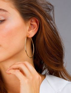 "The perfect earrings for women, gift these hoop earrings to someone special or yourself, these large hoops are classic due to their thin design. Get them in 14k gold vermeil or sterling silver. DETAILS: All hoops are sold in pairs. Diameter: 57mm Width: 1.9mm QUALITY: * 100% 14k Gold Vermeil or Sterling Silver available What is 14k Gold Vermeil? We thought you would ask! :) 14k Gold Vermeil (pronounced \"ver-may\"), should not be confused with gold plating or filled. Vermeil is a much thicker l Large Gold Hoop Earrings, Blush Jewelry, Earrings Classic, Gold Name Necklace, Hoop Earrings Gold, Creating Jewelry, Elegant Nails, Solid Gold Jewelry, White Jewelry