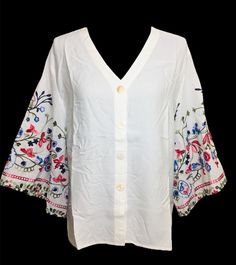 Beautiful cotton embroidered bell sleeve tunic top. Very light and breathable fabric.  An ideal tunic/top for Spring and Summer. Sleeves embellished with multi- color floral embroidery. Looks very elegant and perfect for evening wear, office wear, beach wear, resort wear. Size chart is posted with pics. Casual V-neck Blouse With Embroidered Sleeves, Spring V-neck Blouse With Chikankari Embroidery, Casual V-neck Top With Embroidered Sleeves, Cotton V-neck Blouse With Embroidered Hem, Summer V-neck Blouse With Chikankari Embroidery, Embroidered V-neck Top For Day Out, Cotton V-neck Peasant Top For Vacation, Cotton V-neck Blouse With Embroidered Sleeves, Multicolor Embroidered V-neck Top For Vacation