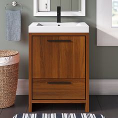 a bathroom with a sink, mirror and rug