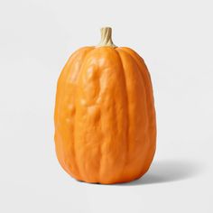 an orange pumpkin sitting on top of a white table