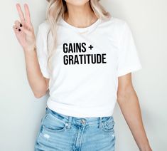 Workout T-Shirt | Gym T-Shirt | Fitness Shirt | Lifting Tee | Workout Gift | Workout Motivation | Gains + Gratitude Gains + Gratitude // The Unisex Tee T H E * D E T A I L S * Crewneck * Short sleeve * Unisex sizing * Handmade to order with high quality vinyl + professional heat press F A B R I C *Black + White - 100% Cotton *Deep Heather - Poly/Cotton Blend C A R E * I N S T R U C T I O N S Turn garment inside out, wash cold, hang dry. Do not iron on design. P R O C E S S I N G * T I M E | O R Boxing Clothes, Boxing Shirts, Funny Gym Shirts, Gym Tees, Fitness Shirt, Heavy Weights, Gym Shirt, Dance Shirts, Yoga Shirts