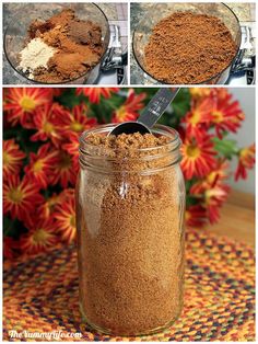 a glass jar filled with brown sugar on top of a table next to red flowers