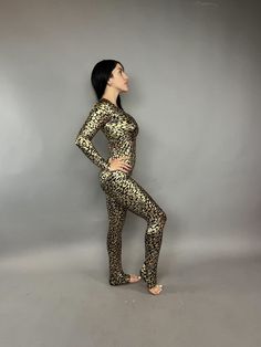 Gold Catsuit - Stunning Costume Bodysuit!Description:Elevate your style with our Gold Cheetah print Catsuit, perfect as a costume for gymnast, dancers, festival fashion and active wear.Features:Long sleeves and a flattering scoop neck for a sleek look.Designed to fit like a glove, offering both softness and firmness for maximum comfort.Fabric Quality:Prepare to be amazed by the brilliance of this fabric! Its shiny finish not only flatters but also enhances your curves effortlessly.Whether you're Stretch Dancewear Bodysuit For Costume Party, Fitted Leopard Print Bodysuit For Party, Spandex Catsuit, Costume Bodysuit, Catsuit Costume, Festival Mode, Bodysuit Costume, Exotic Dance, Will Turner