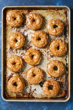 glazed donuts on a baking sheet ready to be baked in the oven for consumption