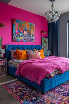 a colorful bedroom with pink walls, blue bedding and rugs on the floor