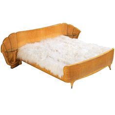 a bed with white fur on top of it and a wooden frame in the shape of a couch