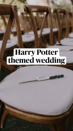 row of wooden chairs with harry potter themed wedding written on the seat back in white