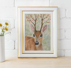 a painting of a deer is displayed next to a vase with daisies in it