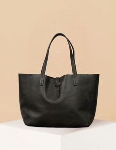 The Mika Bag is a sleek and versatile accessory designed for those who appreciate minimalist elegance. Crafted from premium leather and suede, this tote is perfect for both everyday use and special occasions. Its clean lines and structured silhouette provide a refined look, while its spacious interior allows you to carry all your essentials with ease. Featuring sturdy shoulder straps and a simple buckle closure, the Mika Bag is as practical as it is stylish. Available in luxurious jet black leat Poncho Jacket, Belt Top, Belt Shop, Jet Black, Card Sizes, Clean Lines, Shoulder Straps, Accessories Design, Timeless Fashion