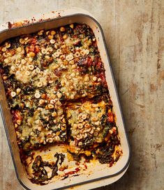 a casserole dish with spinach and other toppings