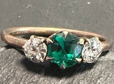 "Edwardian 14k ring-old European Cut Diamonds(approx. 1/3 carat total wt.-2 stones), Emerald paste Center.  Size 4 3/4, wt. 1.5 grams.  A classic antique Beauty, love the color and scale of this design-it's a classic.  The condition is very good, stones prong set-simple elegant look to the ring, there is a bit of wear to the Emerald paste stone commensurate with it\"s age_need a loupe to see it.  Gorgeous easy to wear-the photos say it all." Classic Elegant, 3 Carat, European Cut Diamonds, Prong Setting, Rings Statement, Elegant Design, Emerald, Statement Rings, Diamond Cuts