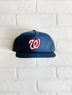 Vintage Washington Nationals Hat - (New) Unstructured 5 Panel Snapback in NavyClosure - 7 Button Plastic SnapColor - NavyConstruction - 6 Panel SnapbackContents - 60% Cotton / 40% PolyesterProfile - 3.25"Size - One Size Fits All (6 ⅝” – 7 ⅝”)Structure - Lightly Structured- Flocked Nationals Patch Dodger Hats, Chicago Gifts, Cubs Hat, Different Hats, Vintage Los Angeles, Washington Nationals, Quality Hats, Custom Hats, Snapback Hat