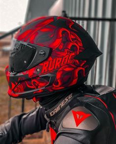 a person wearing a red and black motorcycle helmet