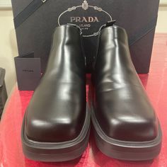 Brand New Never Worn Men’s Prada Leather Chelsea Boots Bought From Prada. Includes Brand New Box. Amazing Gift As The Holidays Are Coming Up. Luxury Slip-on Business Boots, Designer Chelsea Boots With Round Toe For Work, Black Chelsea Boots With Lug Sole For Formal Occasions, Formal Black Chelsea Boots With Leather Footbed, Elegant Chelsea Boots With Lug Sole For Formal Occasions, Designer Chelsea Boots With Leather Sole For Business, Designer Chelsea Boots With Round Toe For Formal Occasions, Luxury Chelsea Boots With Round Toe For Business, Designer Formal Chelsea Boots With Round Toe