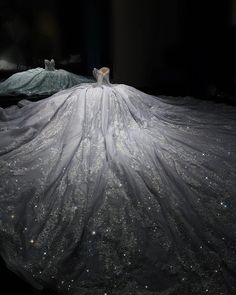 a woman in a white dress standing on top of a bed covered in silver stars