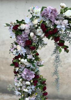 a floral arch decorated with flowers and greenery