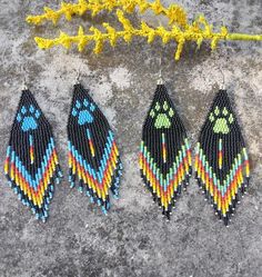 These Native American bear paw fringe earrings are made from high quality Miyuki and Czech seed beads and hex beads to add some extra sparkle. They come in your choice blue or green. I love the fire colors on the fringe. 100% handmade with passion and attention to detail. Each piece can take hours to complete. Great to wear for any occasion and would be a nice addition to your wardrobe. Fun to wear!  They would also make a great gift! Please check out the many other listings in my shop! https://barbsbeadingstudio.etsy.com I've made every effort to get accurate photos so you can see all the details. If you still have any questions, please message me and I will be glad to help you. Handmade in the heart of Oklahoma, USA Thank you for visiting and please come again! Barbara Native American Bear, Bear Paw, Handmade Earring, Earring Gift, Bear Paws, Southwest Style, Earring Gifts, Handmade Earrings