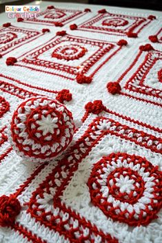 red and white crocheted tablecloth with buttons on it's center piece