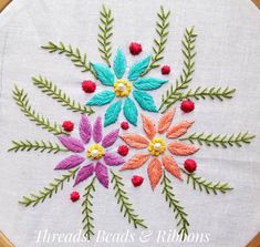 the embroidery is colorful and has flowers on it