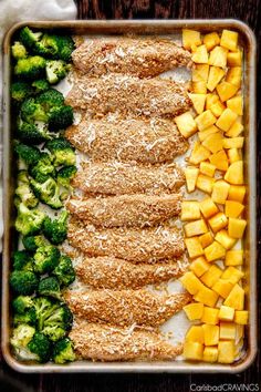 a pan filled with broccoli, pineapples and other vegetables on top of a wooden table