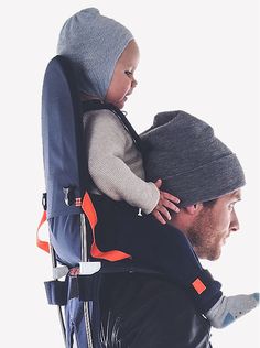 a man carrying a child on his back