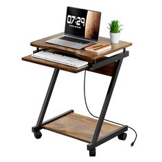 a laptop computer sitting on top of a wooden desk next to a keyboard and mouse