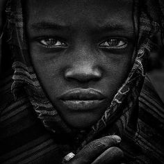 a black and white photo of a woman with blue eyes