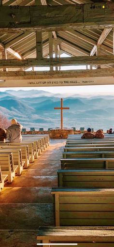 the inside of a church with pews and an open door leading to another room