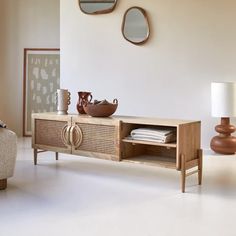 a living room with furniture and mirrors on the wall