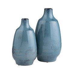 two blue vases sitting next to each other