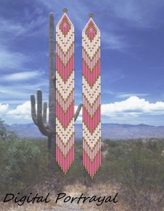 a pair of pink and white beaded earrings sitting on top of a cactus