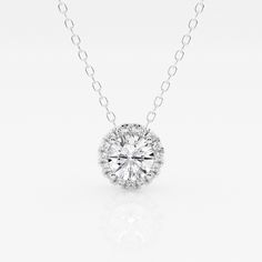 A diamond with a fine halo is better than none! This beautiful round lab grown diamond pendant is encircled with tiny shimmering smaller diamonds, to Luxury Diamond Necklace With Round Pendant And Cable Chain, Anniversary Halo Solitaire Necklace In Cubic Zirconia, Anniversary Halo Solitaire Cubic Zirconia Necklace, Cubic Zirconia Solitaire Necklace With Halo Design For Anniversary, Sterling Silver Diamond White Necklace With Halo Design, Dazzling Cubic Zirconia Diamond Necklace With Halo Design, White Solitaire Necklace With Halo Design In Sterling Silver, White Sterling Silver Solitaire Necklace With Halo Design, Diamond White Solitaire Necklace With Halo Design