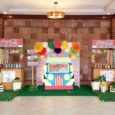 an ice cream truck is parked in front of a wall decorated with balloons and streamers