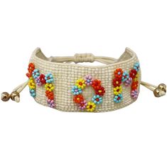 a white beaded bracelet with beads and bells on the end, in multicolored beads